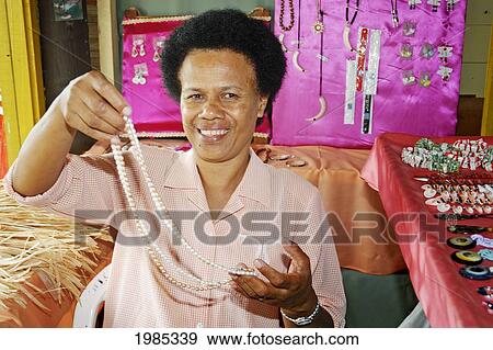 Fiji, Viti Levu, Sigatoka, Fijian Woman Selling Jewelry At A Market Stand. For Editorial Use Only. View Large Photo Image Stock Photo - Fiji, Viti Levu, Sigatoka, Fijian Woman Selling Jewelry At A Market Stand. For Editorial Use Only.. Fotosearch