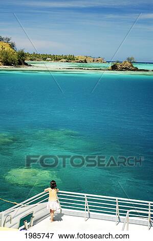 Fiji, Yasawas, Nacula Island, Young Tourist Girl On Catamaran Looking Out At Turquoise Water And Reef. View Large Photo Image Stock Photo - Fiji, Yasawas, Nacula Island, Young Tourist Girl On Catamaran Looking Out At Turquoise Water And Reef.. Fotosearch