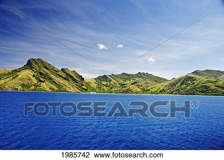 Stock Image - Fiji, Yasawas, Waya Island, Captain Cook Cruise Ship Passes Green Mountains, View From Ocean.. Fotosearch