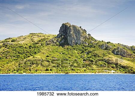 Stock Image - Fiji, Yasawas, Waya Lailai Island, Vatuvula Rock Above Waya Lailai Eco Haven Resort, View From Ocean.. Fotosearch