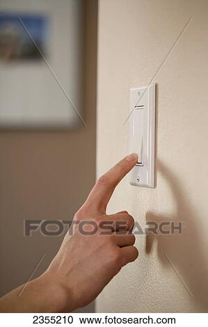 Stock Image - Finger Turning Off Light Switch; Halifax, Nova Scotia, Canada. Fotosearch