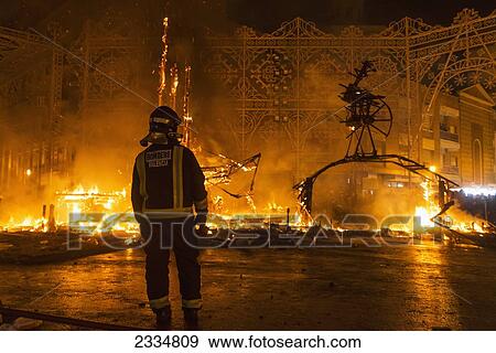 Fireman Watching Burning Falla On Fallas Festival; Valencia, Spain View Large Photo Image Stock Photo - Fireman Watching Burning Falla On Fallas Festival; Valencia, Spain. Fotosearch