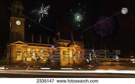 Stock Photo - Fireworks And A Full Moon In The Night Sky Over An Illuminated Building; South Shields, Tyne And Wear, England. Fotosearch