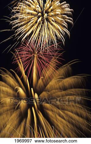 Fireworks Bursting Against A Night Sky. View Large Photo Image Stock Photo - Fireworks Bursting Against A Night Sky.. Fotosearch