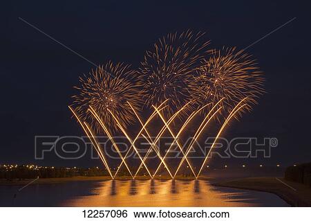 Stock Photograph - Fireworks reflecting on a lake; Calgary, Alberta, Canada. Fotosearch