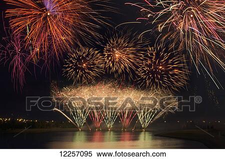 Stock Photography - Fireworks reflecting on a lake; Calgary, Alberta, Canada. Fotosearch