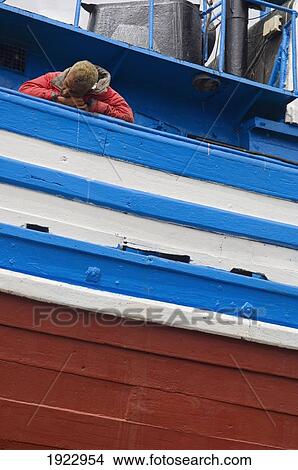 Picture - Fisherman Asleep Onboard Boat. Fotosearch