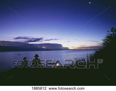 Fisherman In Dugout Canoe Going Past As Couple Having Sundowner Drinks At Sunset On Domwe Island View Large Photo Image Stock Image - Fisherman In Dugout Canoe Going Past As Couple Having Sundowner Drinks At Sunset On Domwe Island. Fotosearch
