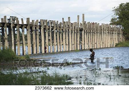 Fisherman in front of U Bein Bridge, made of Teak wood; Mandaly, Burma View Large Photo Image Stock Image - Fisherman in front of U Bein Bridge, made of Teak wood; Mandaly, Burma. Fotosearch