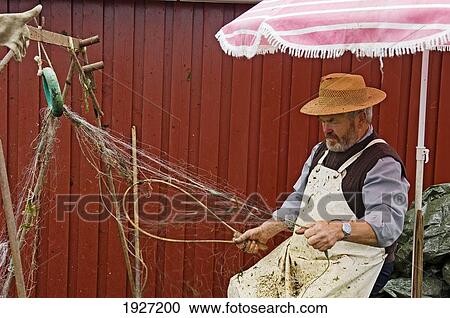 Fisherman Repairing His Nets Ringkobing, Situated Right By The Inlet Ringkobing Fjord, West Jutland Denmark View Large Photo Image Stock Image - Fisherman Repairing His Nets Ringkobing, Situated Right By The Inlet Ringkobing Fjord, West Jutland Denmark. Fotosearch