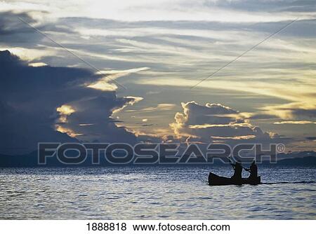 Fishermen Going Past Island Of Domwe At Dusk View Large Photo Image Stock Photo - Fishermen Going Past Island Of Domwe At Dusk. Fotosearch