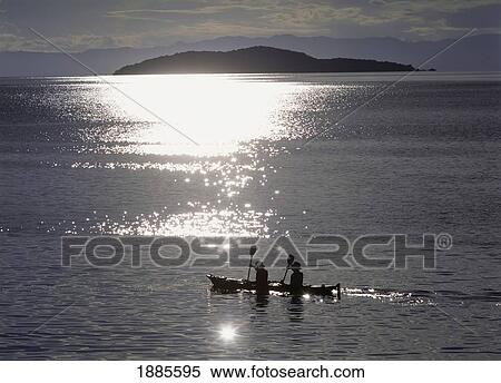 Stock Photography - Fishermen Going Past The Island Of Domwe At Dusk. Fotosearch
