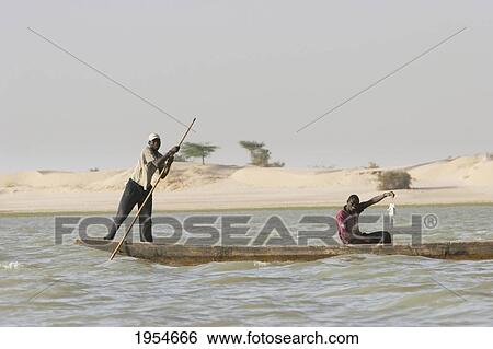 Stock Photograph - Fishermen on a boat on the Niger River between Niafunke and Kabara, Mali. Fotosearch