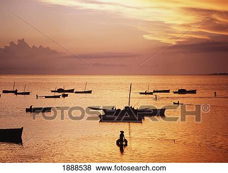 Stock Photo - Fishermen Preparing Their Dhows Before Heading Out To Sea At Dawn. Fotosearch