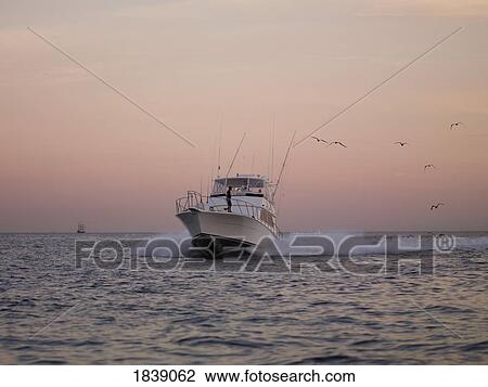 Fishing Boat Approaching Cabos San Lucas At Sunset; Los Cabos, Mexico View Large Photo Image Stock Image - Fishing Boat Approaching Cabos San Lucas At Sunset; Los Cabos, Mexico. Fotosearch