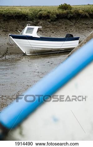 Stock Image - Fishing Boat In Mud Of Small Estuary. Fotosearch