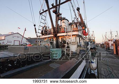 Stock Image - Fishing Boat In The South Arm Of The Fraser River By The Historic Fishing Village Of Steveston At Dusk, Richmond, British Columbia, Canada. Fotosearch