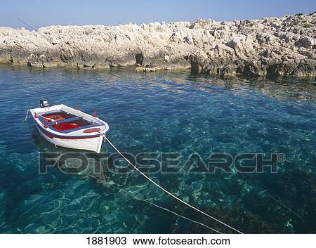 Stock Image - Fishing Boat Moored Off Alikes Beach. Fotosearch