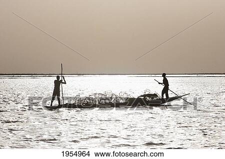 Fishing boat on Lake Debo, formed by the seasonal flooding of the Niger River, Mali View Large Photo Image Picture - Fishing boat on Lake Debo, formed by the seasonal flooding of the Niger River, Mali. Fotosearch