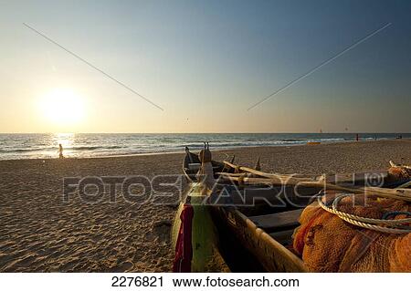 Fishing boat on the beach at Candolim; Goa, India View Large Photo Image Stock Image - Fishing boat on the beach at Candolim; Goa, India. Fotosearch