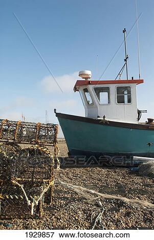 Fishing boat pulled to shore on Aldeburgh beach, Suffolk, UK View Large Photo Image Stock Photo - Fishing boat pulled to shore on Aldeburgh beach, Suffolk, UK. Fotosearch