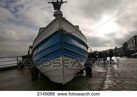 Stock Photograph - Fishing boat waiting for the tide to turn; Filey, Yorkshire, England. Fotosearch
