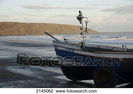 Stock Image - Fishing boats and Filey Brig; Filey, Yorkshire, England. Fotosearch