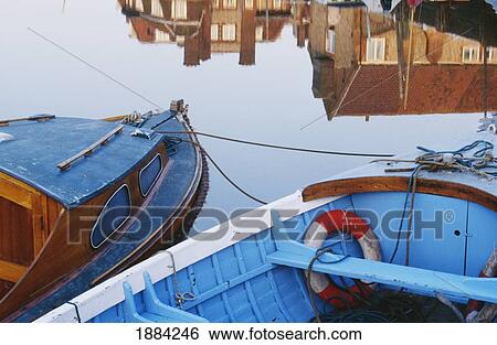 Stock Photograph - Fishing Boats And Reflection Of Houses In Harbor, Blakeney. Fotosearch