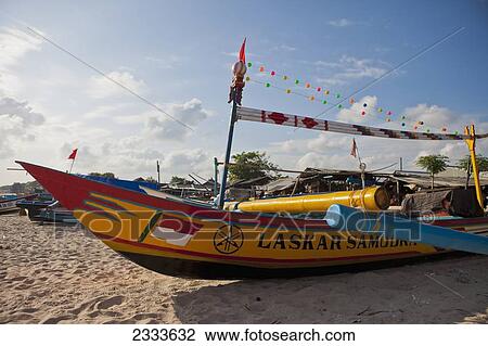Stock Image - Fishing Boats Are Docked On The Beaches Of Jimbaran; Bali, Indonesia. Fotosearch