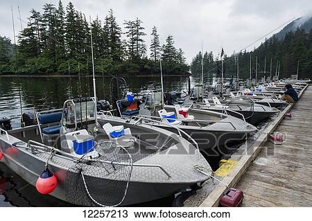 Stock Image - Fishing boats docked in a line; Queen Charlotte Islands, British Columbia, Canada. Fotosearch