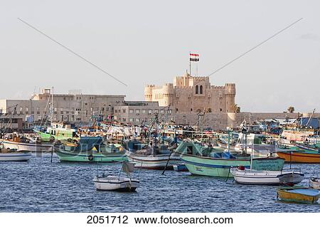 Stock Image - Fishing Boats In The Eastern Harbour And Fort Qaitbey, Alexandria, Al Iskandar. Fotosearch