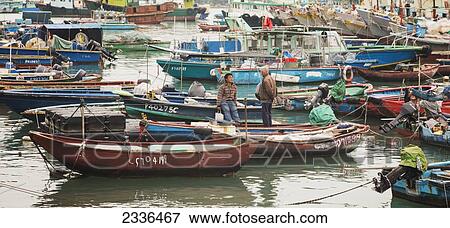 Fishing Boats In The Harbour And A Young Man And Old Man Conversing On Boat Near Cheung Chau Island; Hong Kong, China View Large Photo Image Stock Photo - Fishing Boats In The Harbour And A Young Man And Old Man Conversing On Boat Near Cheung Chau Island; Hong Kong, China. Fotosearch