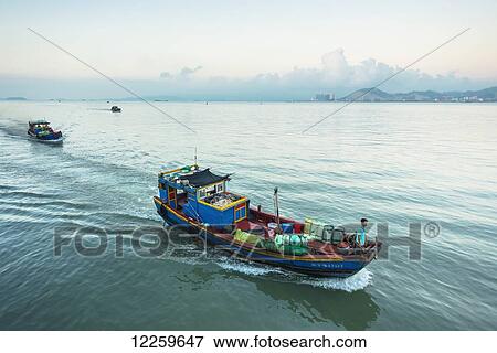 Stock Photo - Fishing boats on Xiamen's bay; Xiamen, Fujian, China. Fotosearch