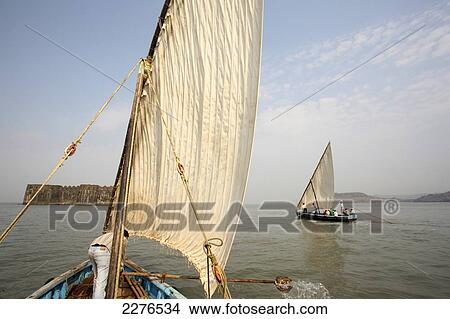 Picture - Fishing boats with sails on the Arabian sea coast; Murud, Maharashtra, India. Fotosearch