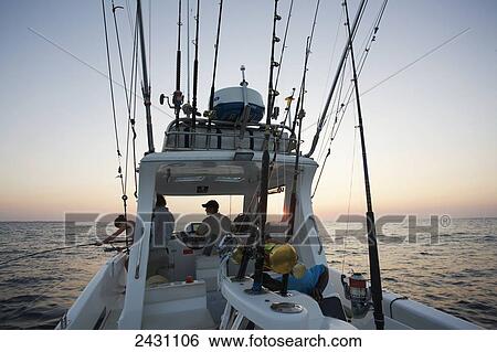 Fishing from a boat at sunset; Vamizi Island, Mozambique View Large Photo Image Stock Photograph - Fishing from a boat at sunset; Vamizi Island, Mozambique. Fotosearch