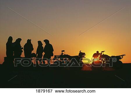 Five Silhouetted People By Quad Bikes At Sunset View Large Photo Image Stock Photo - Five Silhouetted People By Quad Bikes At Sunset. Fotosearch