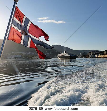 Stock Photo - Flag Of Norway Flying On The Back Of The Boat In The Port; Bergen Norway. Fotosearch