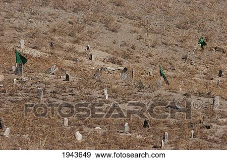 Flags Fluttering In The Wind Over A Muslim Cemetery At The Unai Pass (3, 300 M), Vardak Province, Afghanistan View Large Photo Image Stock Photo - Flags Fluttering In The Wind Over A Muslim Cemetery At The Unai Pass (3, 300 M), Vardak Province, Afghanistan. Fotosearch