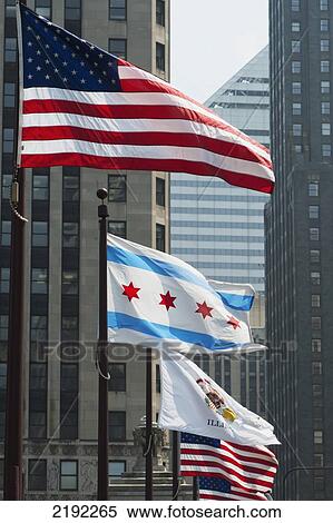 Flags Flying In A Row With Buildings In The Background; Chicago Illinois United States Of America View Large Photo Image Stock Photography - Flags Flying In A Row With Buildings In The Background; Chicago Illinois United States Of America. Fotosearch