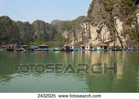 Floating houses in Vung Vieng Fishing Village in Bai Tu Long Bay, Halong Bay; Vietnam View Large Photo Image Stock Photography - Floating houses in Vung Vieng Fishing Village in Bai Tu Long Bay, Halong Bay; Vietnam. Fotosearch