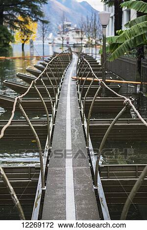 Stock Image - Floating jetty over flooded Lake Maggiore; Locarno, Ticino, Switzerland. Fotosearch