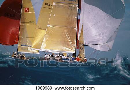 Stock Photo - Florida, Miami, Short Ocean Racing Championship (Sorc), Big Seas With Many Yachts Heading Away, Red And Gold Sails. Fotosearch