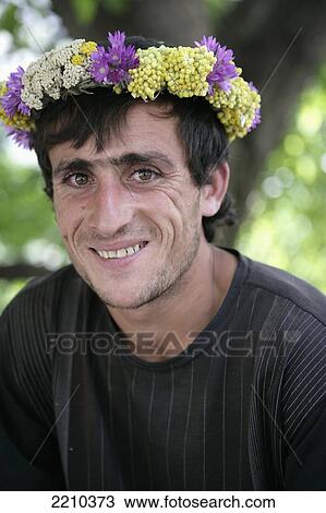 Stock Image - Flower Garland Seller Wearing Flowers On His Head; Armenia. Fotosearch