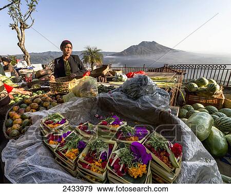 Stock Photo - Flower offerings vendor at the morning market, Kintamani, Bali, Indonesia. Fotosearch
