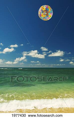 Flowered beach ball in air above ocean View Large Photo Image Stock Image - Flowered beach ball in air above ocean. Fotosearch