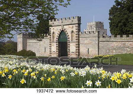 Stock Image - Flowers And Entrance Gate In Front Of Ford Castle; Ford Northumberland England. Fotosearch