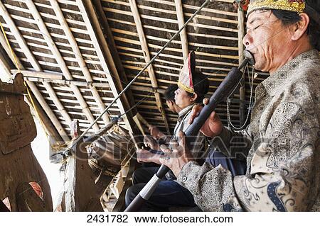 Flute player of a Margondang orchestra at Huta Bolon Museum in Simanindo village on Samosir Island, Lake Toba, North Sumatra, Indonesia View Large Photo Image Stock Image - Flute player of a Margondang orchestra at Huta Bolon Museum in Simanindo village on Samosir Island, Lake Toba, North Sumatra, Indonesia. Fotosearch