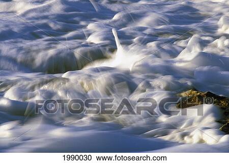Stock Image - Foamy Whitewater Rushing Over Rocks, Motion. Fotosearch