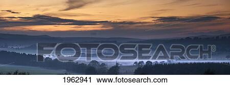 Fog Lies Over A Town At Sunset; Swarland, Northumberland, England View Large Photo Image Stock Image - Fog Lies Over A Town At Sunset; Swarland, Northumberland, England. Fotosearch