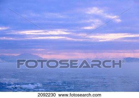 Stock Image - Fog Over Saint Lawrence River At Dawn; Quebec Canada. Fotosearch